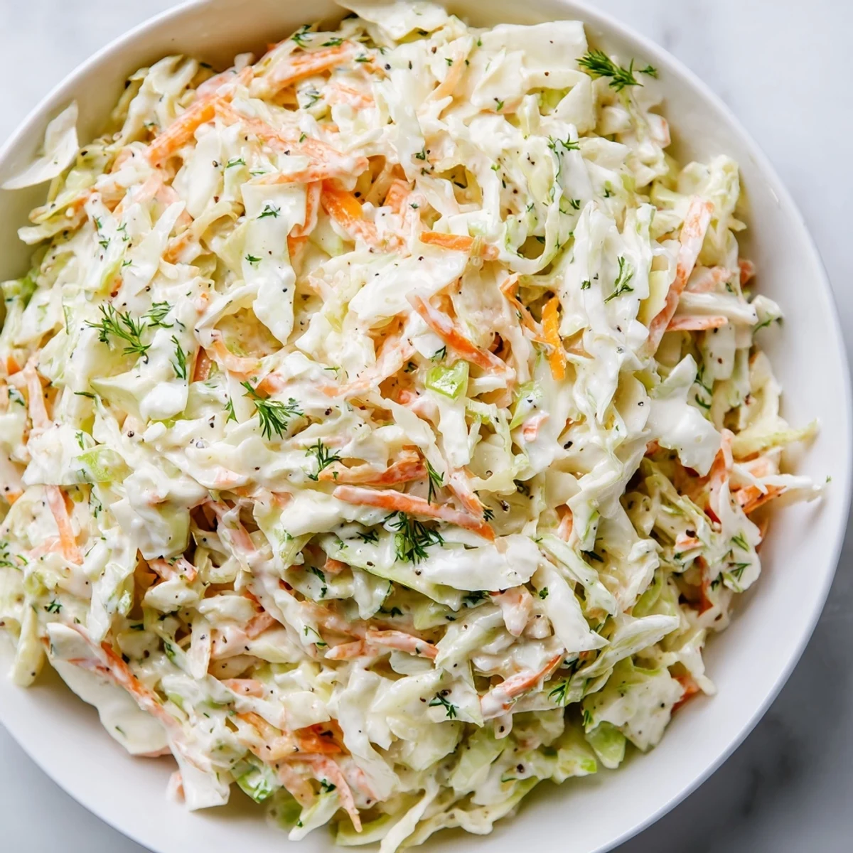 Crisp Coleslaw with Apple, featuring shredded cabbage and sweet apple, ready for a refreshing bite.