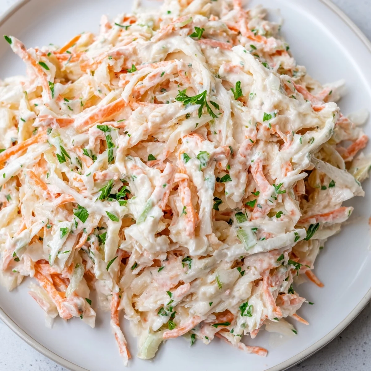 Close-up of fresh Coleslaw with Apple, showing grated apple and colorful vegetables, perfect side dish.