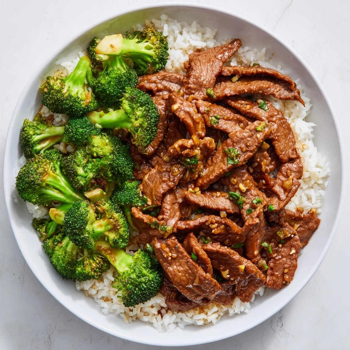 Tender Beef and Broccoli stir-fry, glistening in savory sauce, served over fluffy white rice.