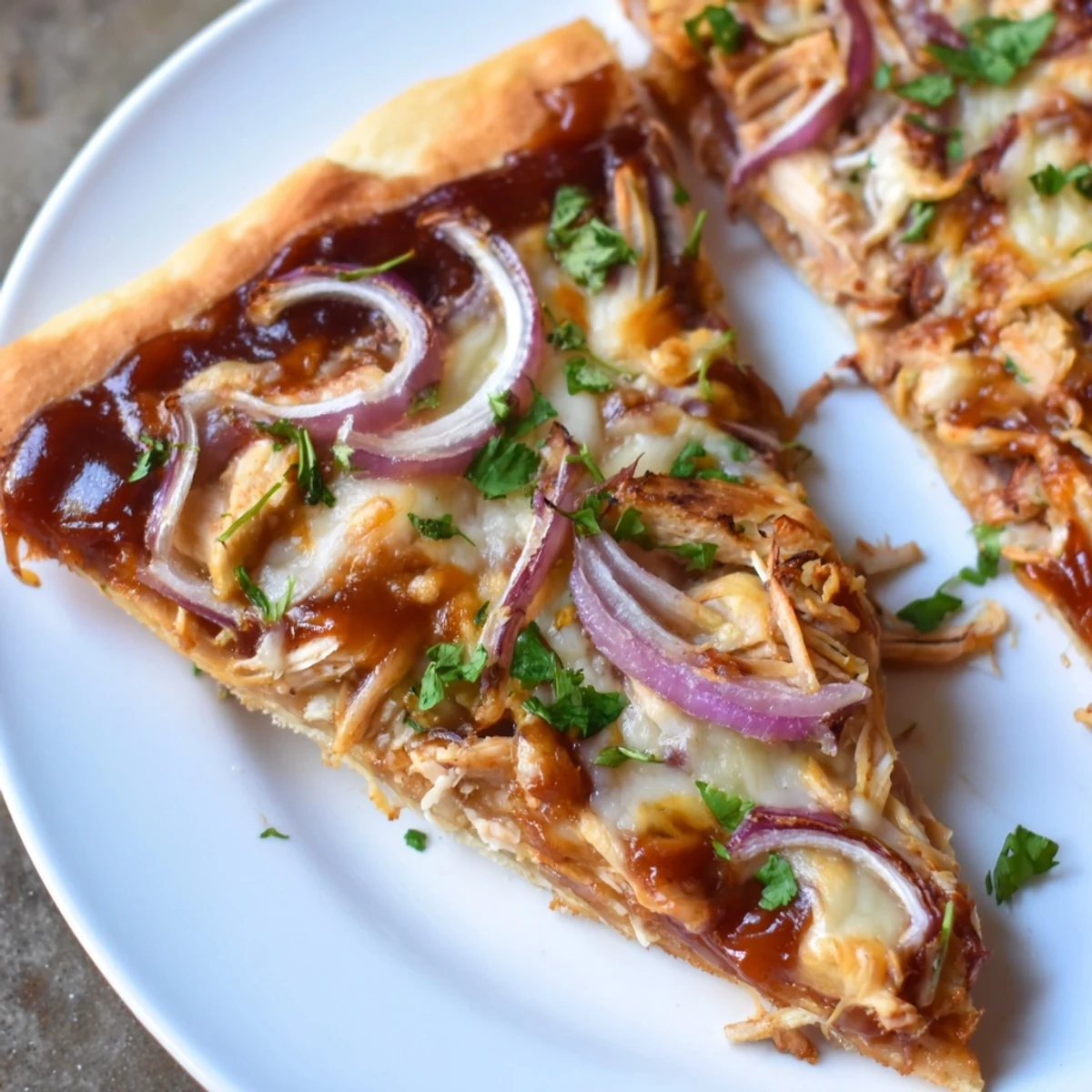 Close-up of a Chicken BBQ Pizza: melted cheese, grilled chicken, and savory aromas tempt.
