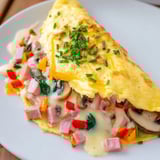 This cheesy Omelet, featuring melted cheese and a fluffy texture, makes a fantastic breakfast.