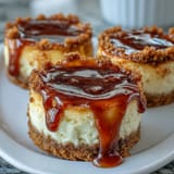 2. Bite-sized creamy cheesecakes baked in mini muffin tins, featuring smooth vanilla filling and optional fruit preserves.