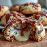 A batch of Cadbury Egg Stuffed Chocolate Chip Cookies with gooey candy centers, fresh from the oven.