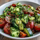 Creamy avocado and juicy tomatoes in a crisp cucumber salad, tossed with zesty lemon dressing.  