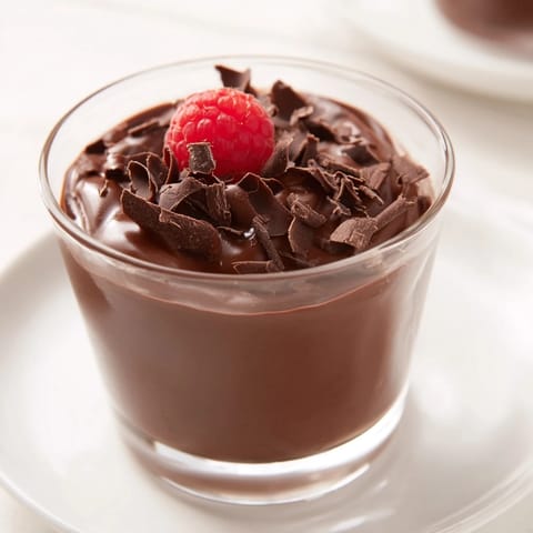 A close-up of smooth, glossy chocolate pudding, ready to be chilled and enjoyed.