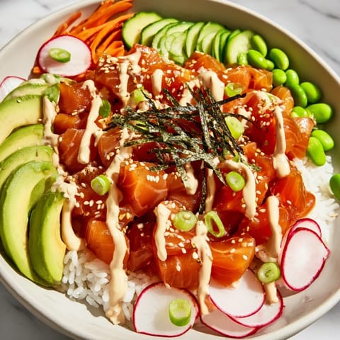 A close-up shot of a homemade poke bowl, showing marinated tuna atop fluffy rice and vibrant toppings.