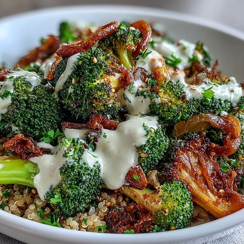 Golden crispy roasted broccoli florets and red onions on a bed of warm quinoa, finished with a drizzle of lemon tahini dressing.