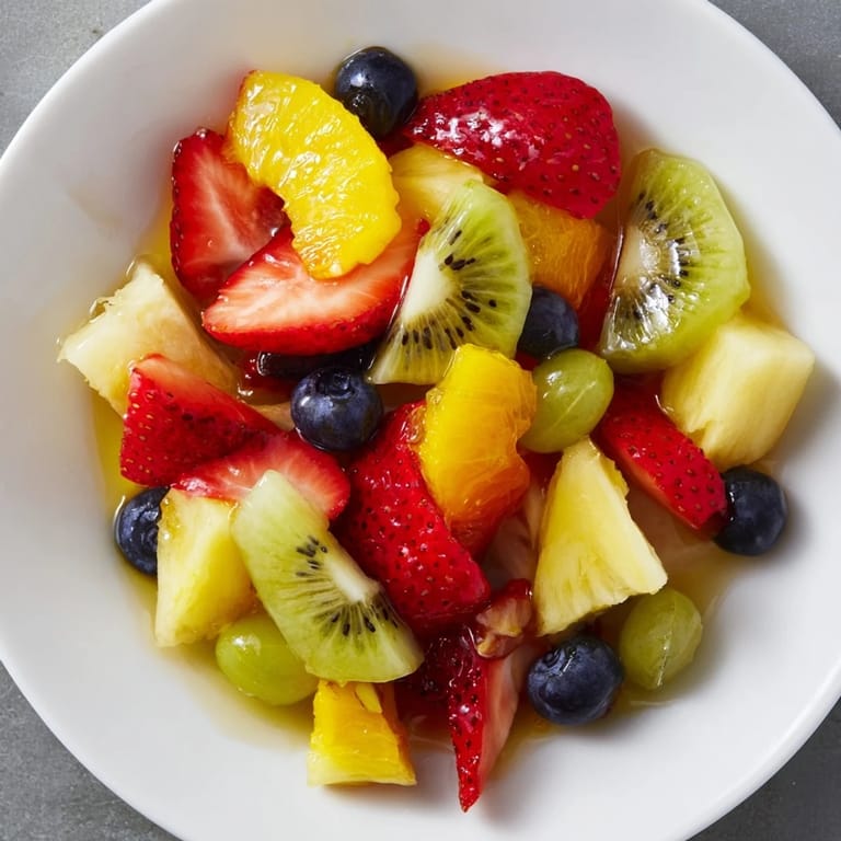 This easy fruit salad features colorful berries and pineapple, drizzled with a light citrus glaze.
