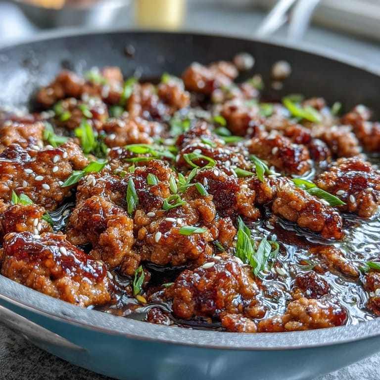 Sizzling skillet of Korean-Style Ground Turkey cooked with minced garlic and fresh ginger in a glossy, spicy-sweet sauce.