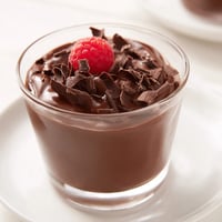 A close-up of smooth, glossy chocolate pudding, ready to be chilled and enjoyed.