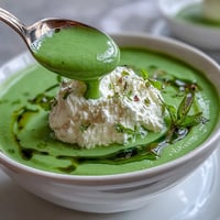 Vibrant spring pea soup with creamy whipped ricotta, perfect for a light lunch.